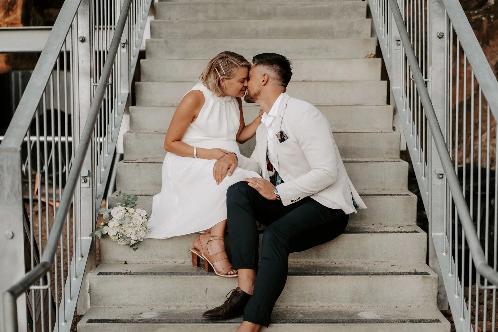 Shannon and Jacksen sitting together on a concrete stairway